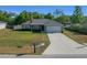 Aerial view of single-story home with a long driveway and well-kept lawn at 5899 Pecan Rd, Ocala, FL 34472