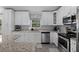 Bright kitchen showcasing modern appliances, granite countertops, and ample cabinet space at 5899 Pecan Rd, Ocala, FL 34472