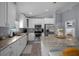 Well-lit kitchen with white cabinetry, granite countertops, and stainless steel appliances at 5899 Pecan Rd, Ocala, FL 34472