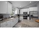 Bright kitchen featuring white cabinets, stainless steel appliances, and granite countertops at 5899 Pecan Rd, Ocala, FL 34472