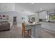 Open-concept living room and kitchen with wood floors and island seating at 5899 Pecan Rd, Ocala, FL 34472