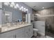 Nicely renovated main bathroom with tiled walk-in shower and double sink vanity at 5899 Pecan Rd, Ocala, FL 34472