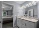 Bright main bathroom has double sink vanity with granite countertop at 5899 Pecan Rd, Ocala, FL 34472