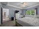 Bright main bedroom features a large window, double dresser, and a make up desk at 5899 Pecan Rd, Ocala, FL 34472