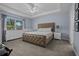 Spacious main bedroom with large window, carpeted floor, and tray ceiling at 5899 Pecan Rd, Ocala, FL 34472