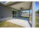 Covered patio with ceiling fan, providing a comfortable outdoor space for relaxation and entertaining at 5899 Pecan Rd, Ocala, FL 34472
