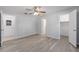 Bedroom features wood floors, ceiling fan, and doors to closet and bath at 614 Third Ave, Lady Lake, FL 32159