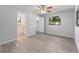 Bedroom features wood floors, ceiling fan, and window with green view at 614 Third Ave, Lady Lake, FL 32159