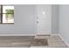 Bright foyer with ceramic tile and wood-look flooring, complemented by a decorative front door at 614 Third Ave, Lady Lake, FL 32159