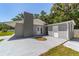 View of the backyard featuring a spacious patio perfect for outdoor entertaining, a lush lawn, and a shed at 6318 Nw 52Nd Ave, Ocala, FL 34482