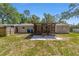 View of the backyard with a screened porch and a home with light gray siding and white trim at 6318 Nw 52Nd Ave, Ocala, FL 34482