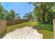 Spacious backyard with mature trees and greenery, with a long driveway leading to a storage shed at 6318 Nw 52Nd Ave, Ocala, FL 34482