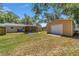 Extensive backyard featuring a screened porch, a storage shed, and lush green grass at 6318 Nw 52Nd Ave, Ocala, FL 34482