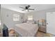 Comfortable bedroom with a large window, stylish furnishings, and ceiling fan at 6318 Nw 52Nd Ave, Ocala, FL 34482