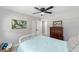 Comfortable bedroom featuring a ceiling fan, closet, painting, and a nice vintage wooden dresser at 6318 Nw 52Nd Ave, Ocala, FL 34482