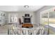 Bright living room with a cozy fireplace, large windows, and neutral color palette at 6318 Nw 52Nd Ave, Ocala, FL 34482