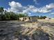 Backyard area featuring a grassy ground and a home exterior in the background at 6658 Sw 165Th Ct, Ocala, FL 34481