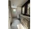 Bathroom with dual sink vanity, framed mirrors, and a separate walk-in closet, providing lots of space at 6658 Sw 165Th Ct, Ocala, FL 34481