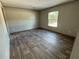 Bedroom featuring vinyl floors, natural light from window, and neutral colored walls at 6658 Sw 165Th Ct, Ocala, FL 34481