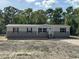 Charming single story home featuring horizontal siding, black shutters, and a front entrance with stairs at 6658 Sw 165Th Ct, Ocala, FL 34481