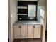 Hallway with storage cabinets, countertops, open shelving, and a window for natural light in a neutral color palette at 6658 Sw 165Th Ct, Ocala, FL 34481