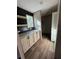 Hallway with storage cabinets, countertops, open shelving, and a window for natural light in a neutral color palette at 6658 Sw 165Th Ct, Ocala, FL 34481