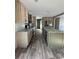 An open kitchen with modern stainless steel appliances and a large island with a sink offers a functional space at 6658 Sw 165Th Ct, Ocala, FL 34481
