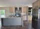 Spacious kitchen featuring modern cabinets, stainless steel appliances, and a kitchen island at 6658 Sw 165Th Ct, Ocala, FL 34481