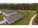 Overhead view of a home's roof and landscaping, surrounded by other houses and lush trees at 716 Hickory Course Loop, Ocala, FL 34472