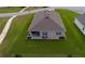 Overhead shot of a home with a covered patio, green lawn, and an encompassing view of the backyard at 716 Hickory Course Loop, Ocala, FL 34472