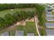Aerial view of homes backing onto a golf course with mature trees and walkable paved path at 716 Hickory Course Loop, Ocala, FL 34472