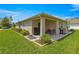 Backyard featuring a covered lanai, a grill, and an outdoor seating area for entertaining at 716 Hickory Course Loop, Ocala, FL 34472