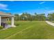 Expansive backyard featuring a covered lanai and lush green lawn at 716 Hickory Course Loop, Ocala, FL 34472