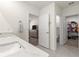 Modern bathroom featuring a marble countertop, double vanity, and doors to bedroom and closet at 716 Hickory Course Loop, Ocala, FL 34472