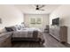 Bright bedroom featuring a ceiling fan, a window with a view, and modern furnishings at 716 Hickory Course Loop, Ocala, FL 34472