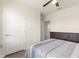 Bedroom showcasing a door, interior access and comfortable bed, and wood-look flooring at 716 Hickory Course Loop, Ocala, FL 34472