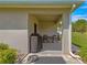 Backyard with a covered lanai featuring a grill and seating area for outdoor enjoyment at 716 Hickory Course Loop, Ocala, FL 34472