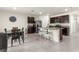 Open floor plan includes dining area adjacent to the kitchen with tile flooring, dark cabinets, and an island at 716 Hickory Course Loop, Ocala, FL 34472