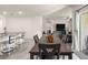 Bright dining area has view into the living room with modern furnishings, neutral paint, and access to the backyard at 716 Hickory Course Loop, Ocala, FL 34472