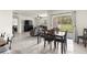 Bright open-concept dining area adjacent to the living room has sliding glass doors leading to outdoor patio at 716 Hickory Course Loop, Ocala, FL 34472