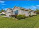 Well-maintained home featuring manicured shrubs and a vibrant green lawn at 716 Hickory Course Loop, Ocala, FL 34472