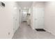 Hallway featuring tile floors, multiple doors and access to other rooms in the home at 716 Hickory Course Loop, Ocala, FL 34472