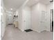 Neutral hallway with doors, tile floors, and entryway access with a hat rack at 716 Hickory Course Loop, Ocala, FL 34472