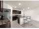 Bright kitchen features dark wood cabinetry, stainless steel appliances, granite counters, and center island with seating at 716 Hickory Course Loop, Ocala, FL 34472