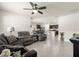 Spacious open floor plan shows living room with a view into the kitchen, dining room, and neutral-colored furniture at 716 Hickory Course Loop, Ocala, FL 34472