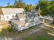 An aerial perspective highlights the home's rear, fenced yard, and mature trees at 721 Ne 2Nd St, Ocala, FL 34470