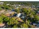 Beautiful aerial view of the property showing a lush tree canopy, neighborhood, and nearby businesses at 721 Ne 2Nd St, Ocala, FL 34470