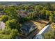 Aerial view of a home, showing the backyard, nearby church and mature trees at 721 Ne 2Nd St, Ocala, FL 34470