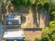 Aerial view offering a unique perspective of the property layout and ample land, nestled among mature trees at 721 Ne 2Nd St, Ocala, FL 34470