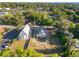 An aerial shot showcases the home, with the yard, church, and mature trees at 721 Ne 2Nd St, Ocala, FL 34470
